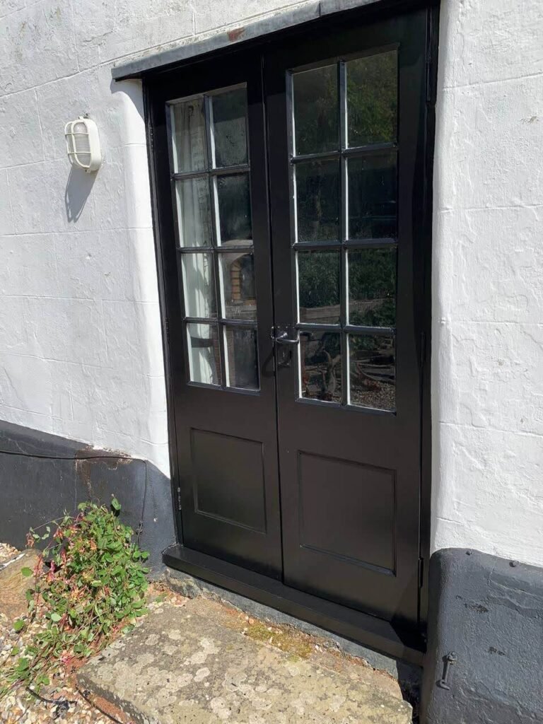 the wooden front door after restoration and painting