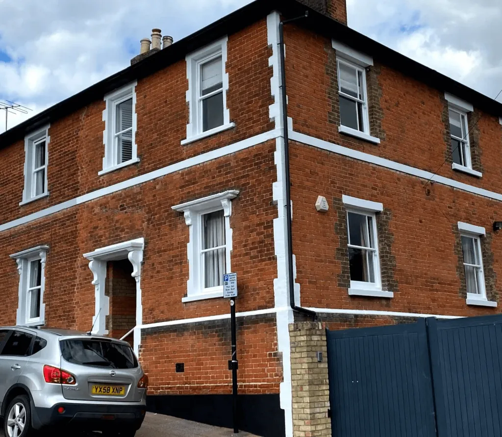 Restored timber sash windows on a brick house by Surrey Sash