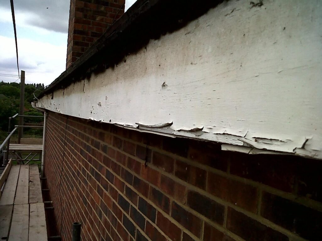 rotten and flacking wooden soffits 